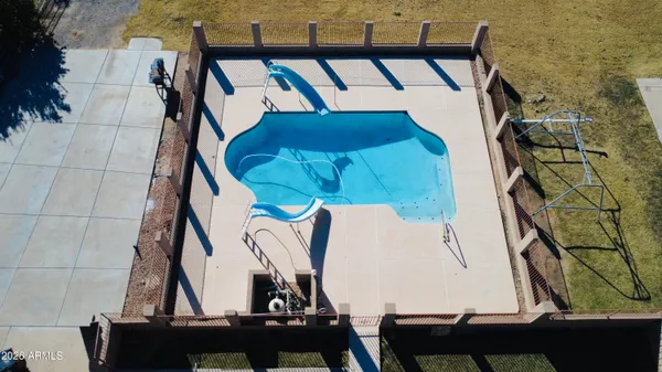 a view of a patio with lawn chairs microwave and floor to ceiling window