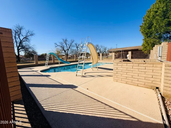 a view of house with backyard and sitting area