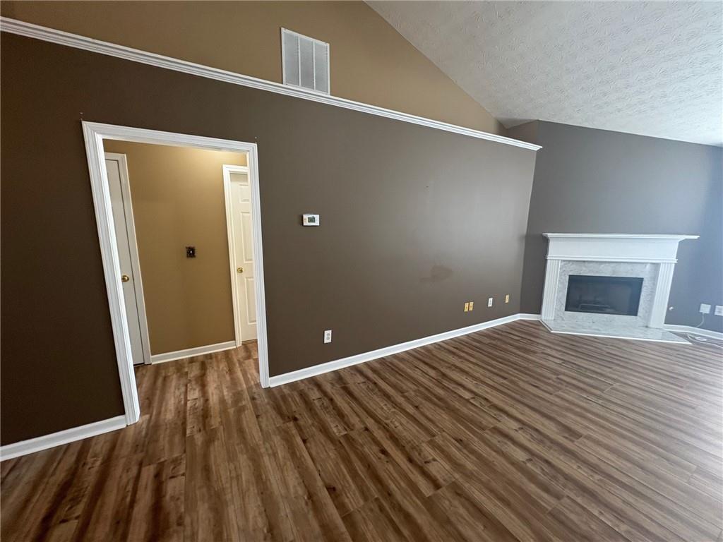 3452 Morning Top Place Suwanee, GA 30024 - Photo 12 of 33 a view of a room with wooden floor and a fireplace
