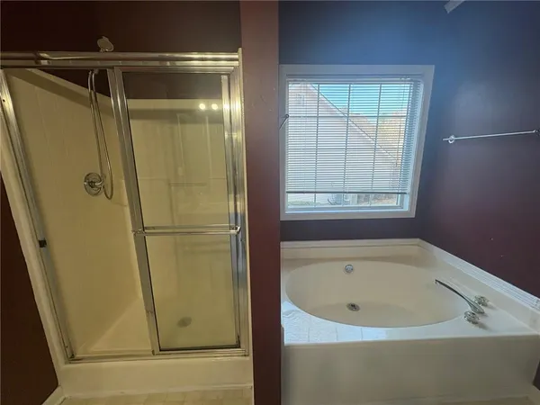 a en suite bathroom with a granite countertop sink and a mirror