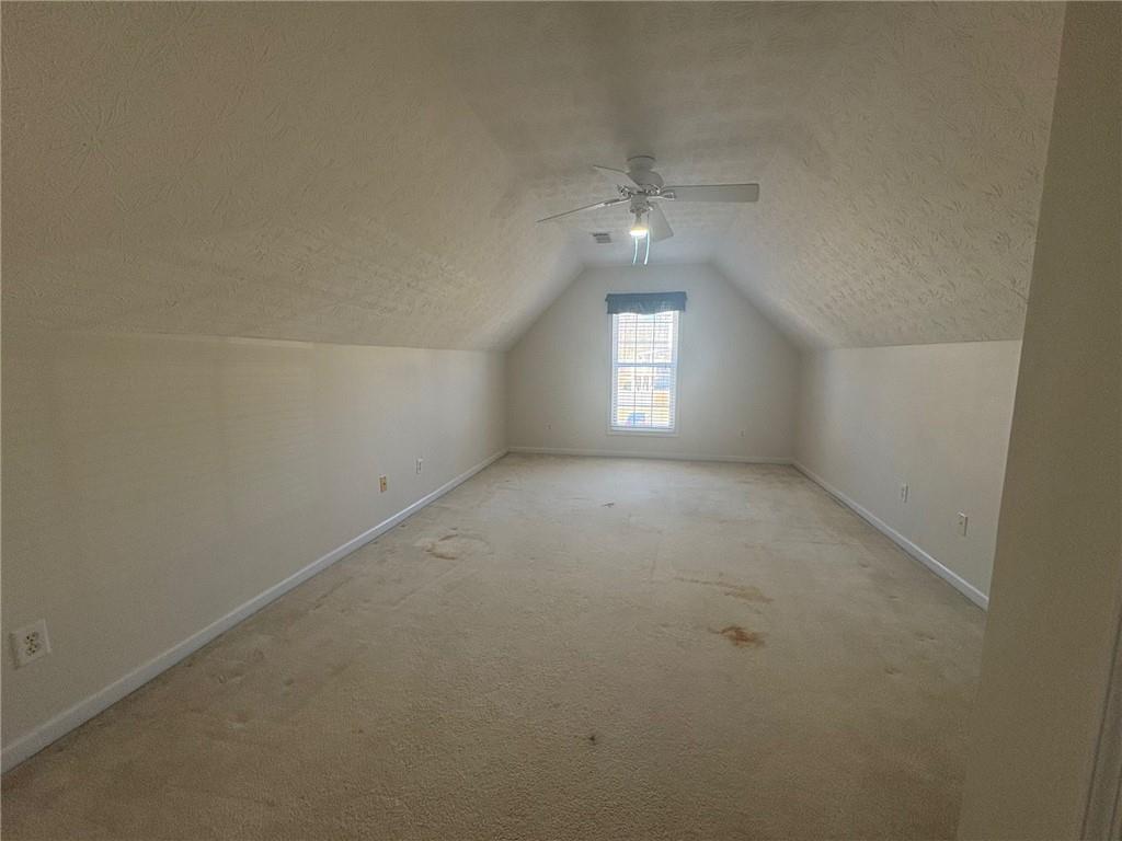 3452 Morning Top Place Suwanee, GA 30024 - Photo 26 of 33 en empty room with windows and chandelier fan