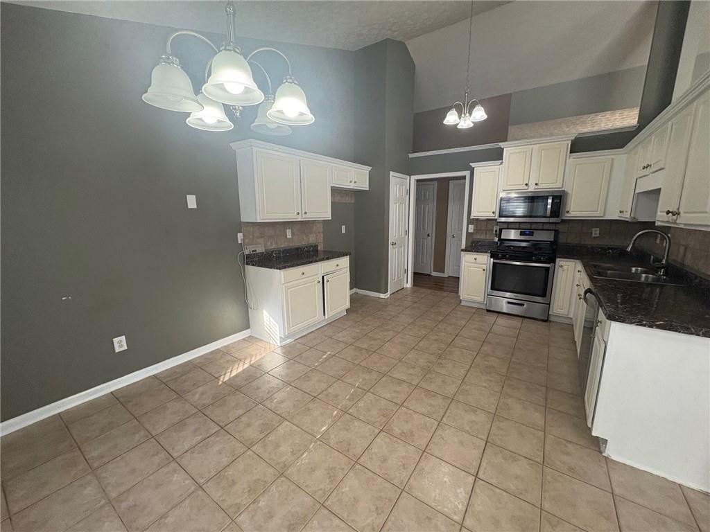 3452 Morning Top Place Suwanee, GA 30024 - Photo 9 of 33 a large kitchen with cabinets