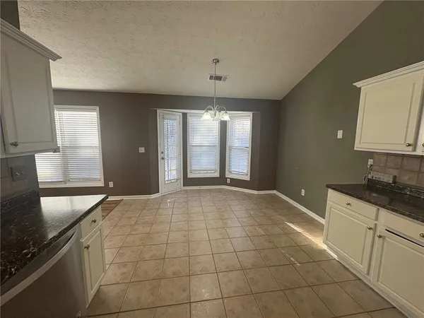 a view of empty room with wooden floor and fireplace