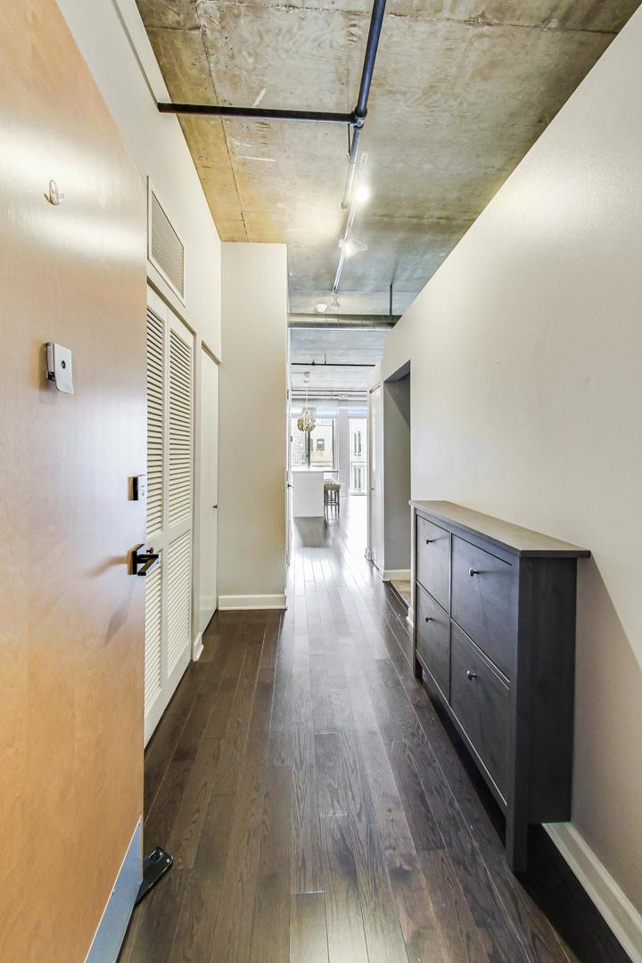 111 South Morgan Street, Unit 522 Chicago, IL 60607 - Photo 12 of 37 a view of a hallway with wooden floor