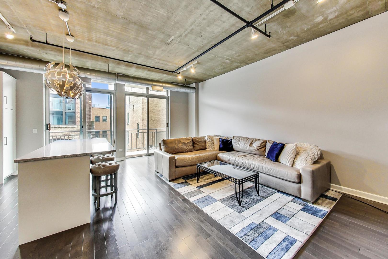 111 South Morgan Street, Unit 522 Chicago, IL 60607 - Photo 14 of 37 a living room with furniture and a large window