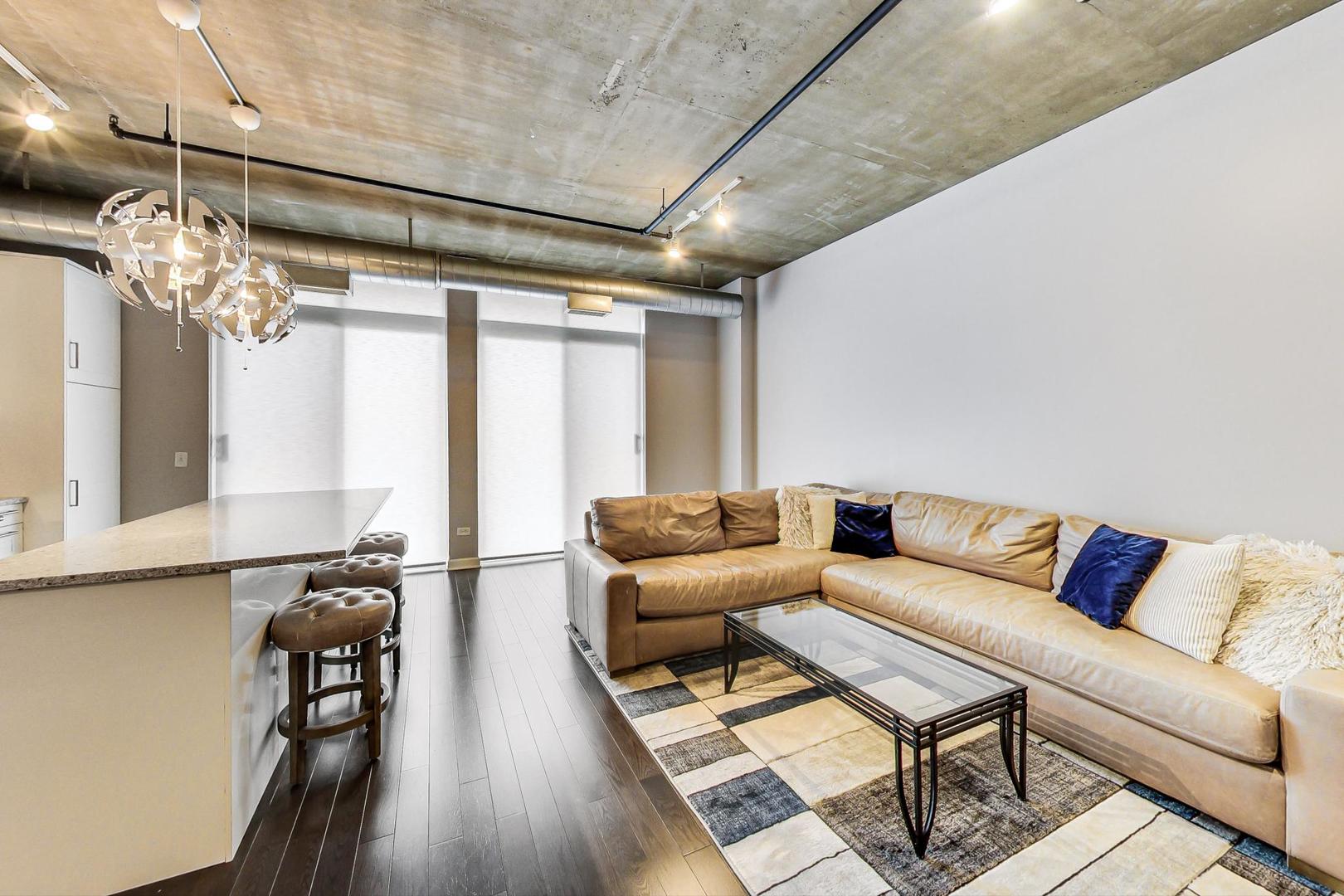 111 South Morgan Street, Unit 522 Chicago, IL 60607 - Photo 15 of 37 a living room with furniture and wooden floor