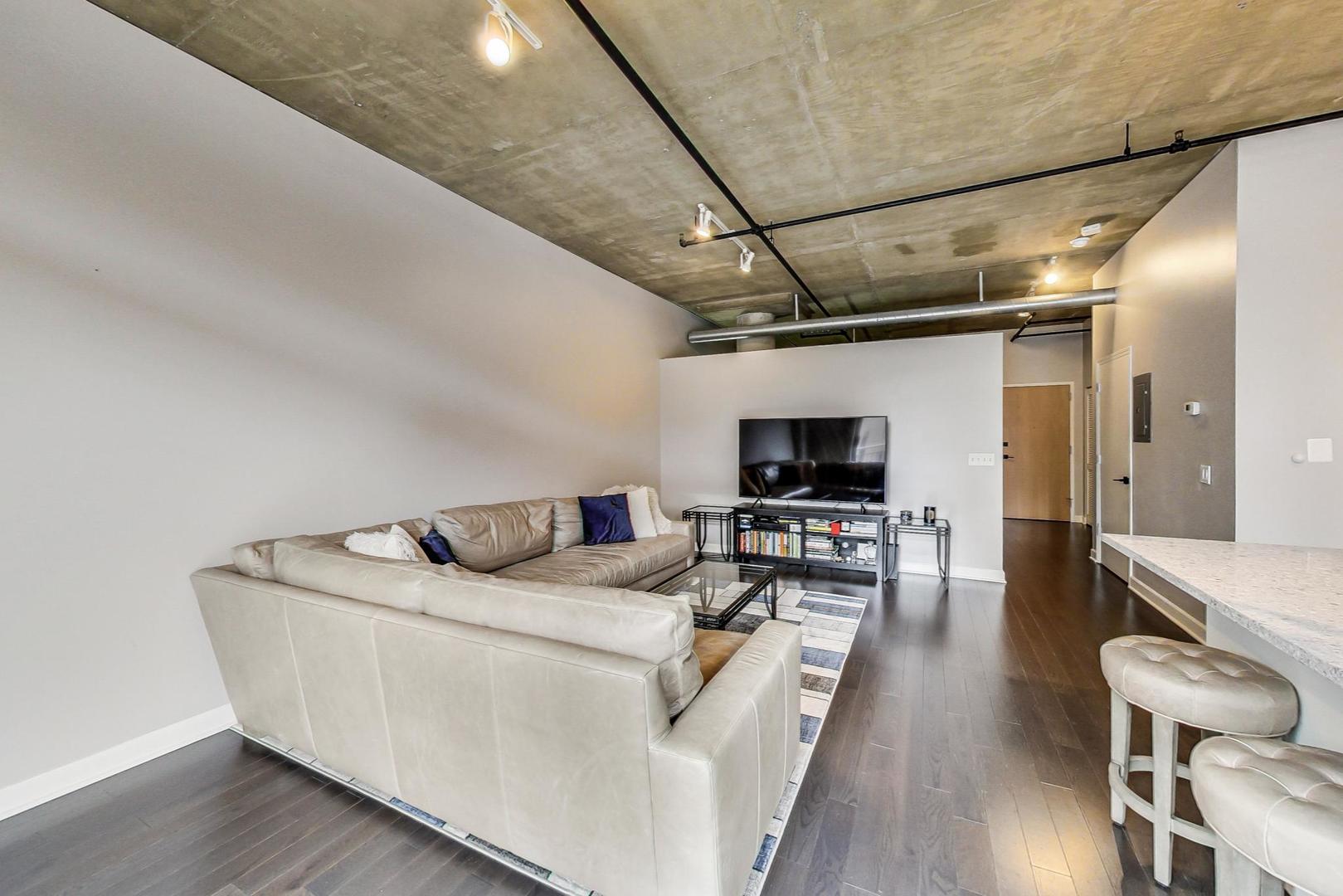 111 South Morgan Street, Unit 522 Chicago, IL 60607 - Photo 20 of 37 a living room with furniture and a flat screen tv