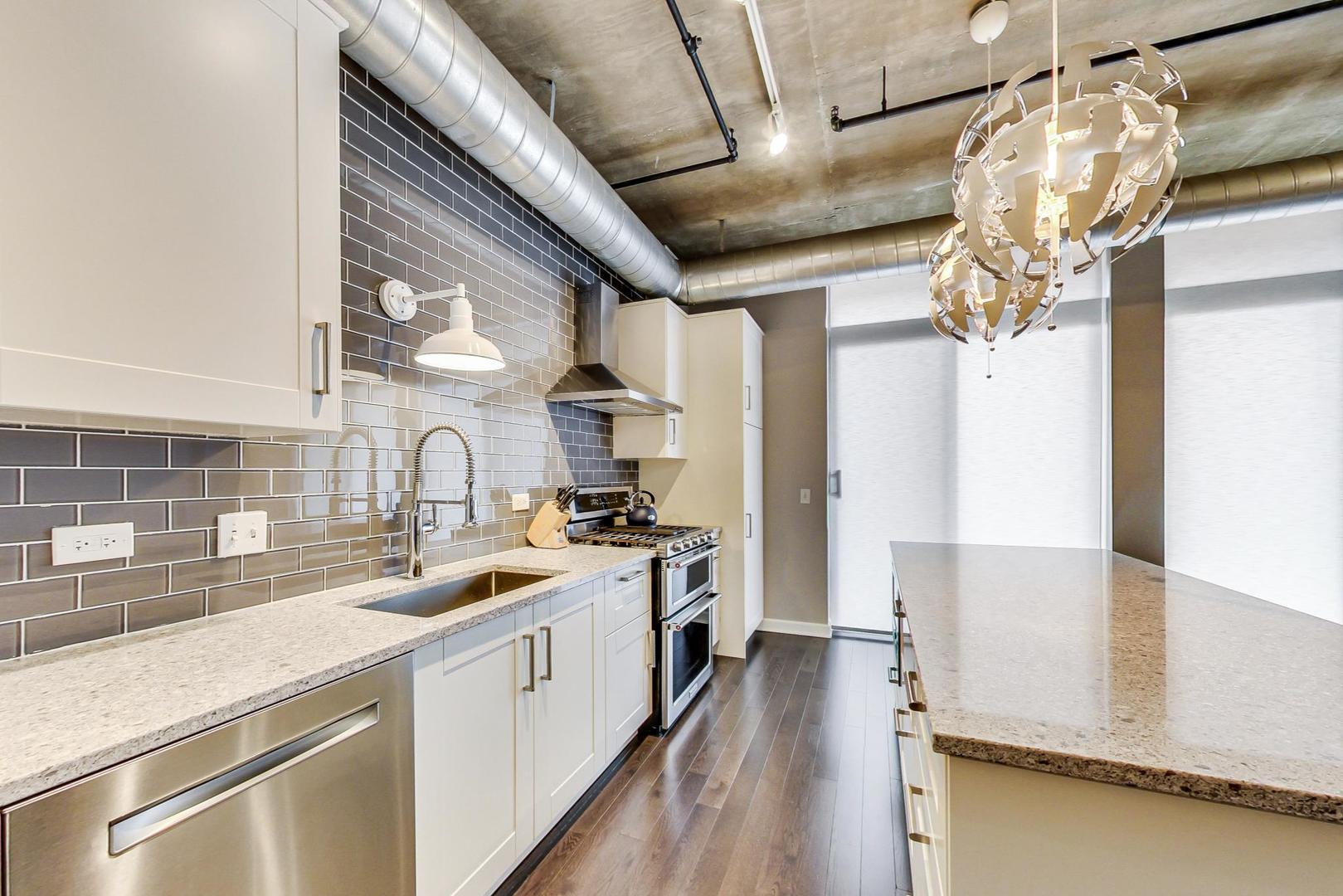 111 South Morgan Street, Unit 522 Chicago, IL 60607 - Photo 24 of 37 a kitchen with a sink stove and cabinets
