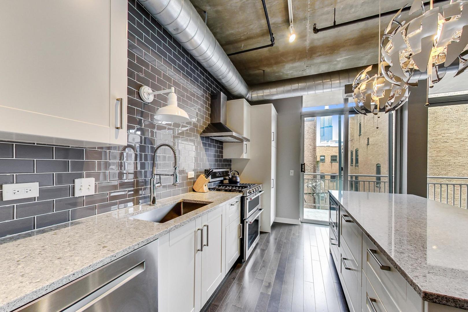 111 South Morgan Street, Unit 522 Chicago, IL 60607 - Photo 25 of 37 a kitchen with counter top space and stainless steel appliances