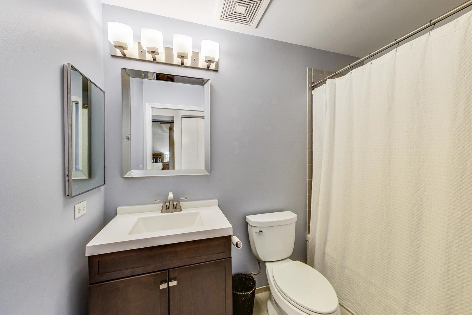 111 South Morgan Street, Unit 522 Chicago, IL 60607 - Photo 26 of 37 a bathroom with a sink vanity mirror and toilet