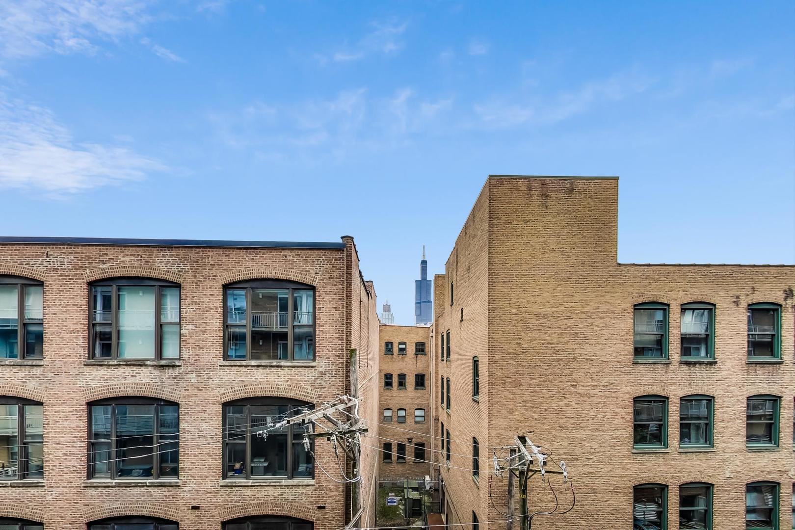 111 South Morgan Street, Unit 522 Chicago, IL 60607 - Photo 33 of 37 a front view of building with a lot of windows