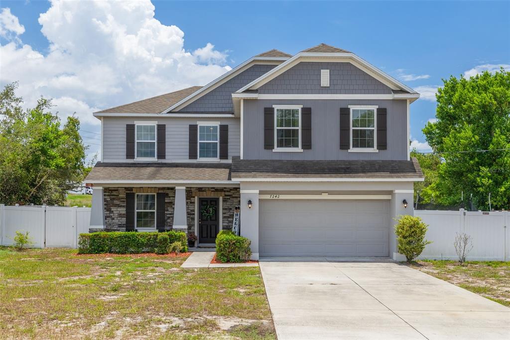 7242 Landmark Drive Spring Hill, FL 34606 - Photo 2 of 45 a front view of a house with garden