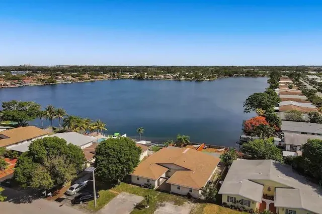 an aerial view of a house with a lake view
