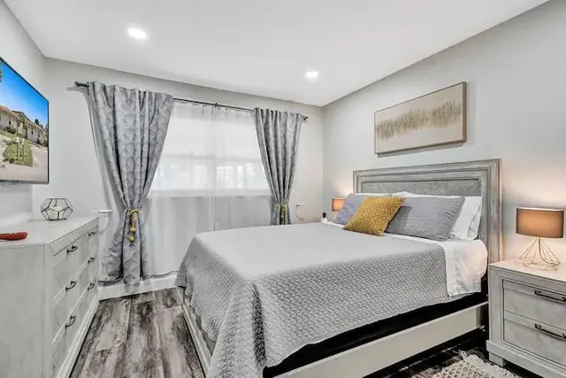 a bedroom with a large bed and a window