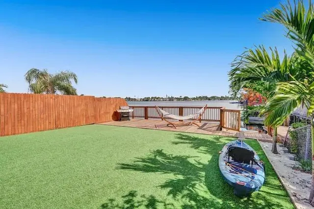 a backyard of a house with table and chairs