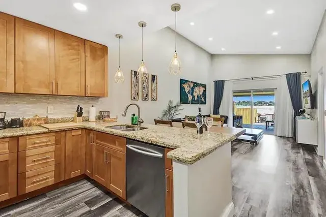 a kitchen with sink refrigerator and cabinets