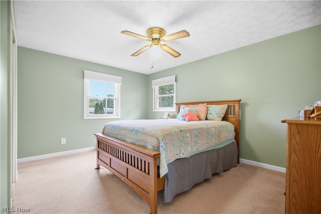 5972 Keller Road Akron, OH 44319 - Photo 15 of 29 Plush carpeting, light green wall paint, and a ceiling fan with integrated lighting