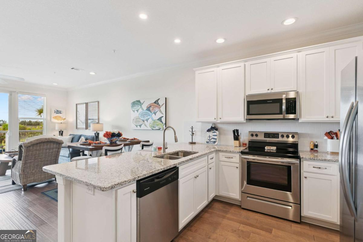 16 Hidden Harbor Road Brunswick, GA 31525 - Photo 18 of 42 a kitchen with a sink a stove and cabinets