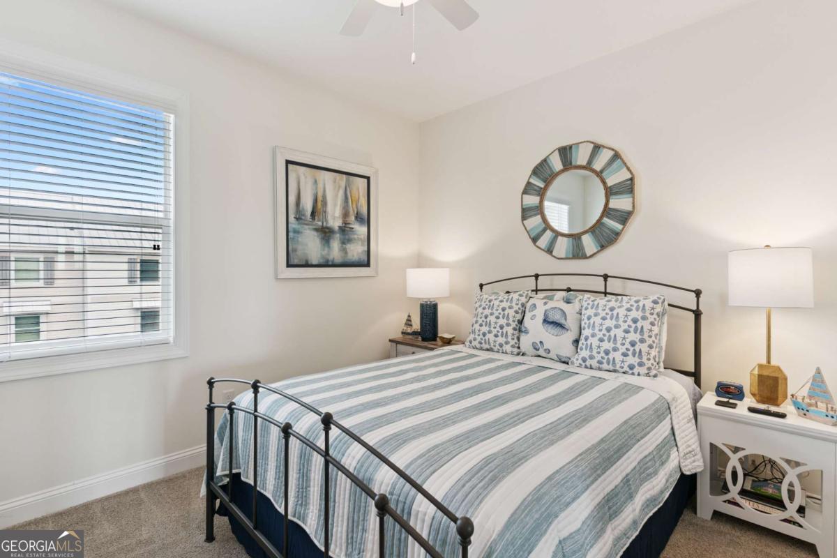 16 Hidden Harbor Road Brunswick, GA 31525 - Photo 29 of 42 a bedroom with a bed and a chandelier