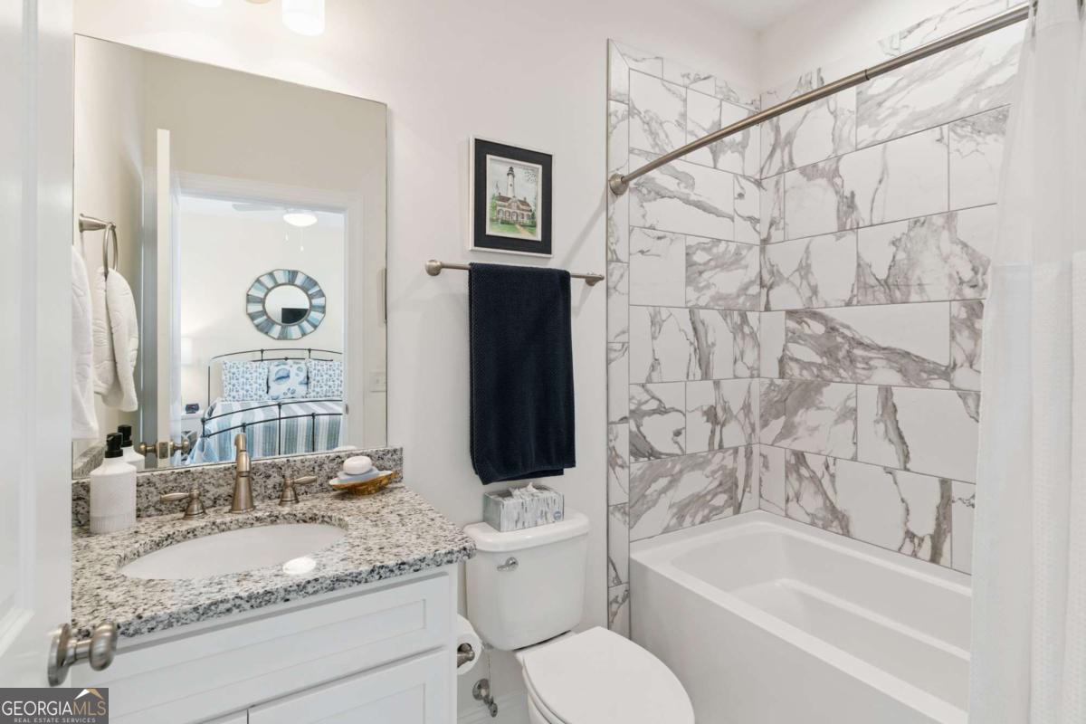 16 Hidden Harbor Road Brunswick, GA 31525 - Photo 31 of 42 a bathroom with a granite countertop toilet sink and mirror