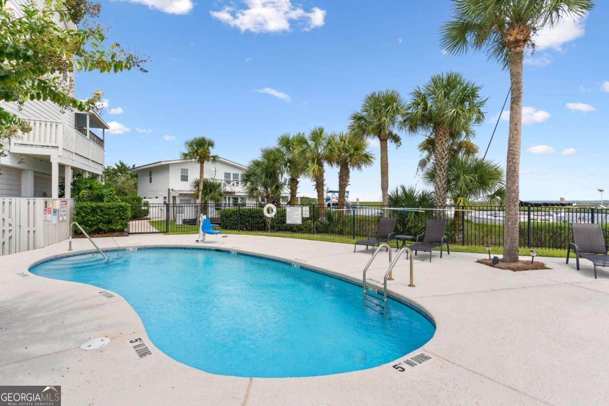 16 Hidden Harbor Road Brunswick, GA 31525 - Photo 5 of 42 a view of a swimming pool with a patio and a garden