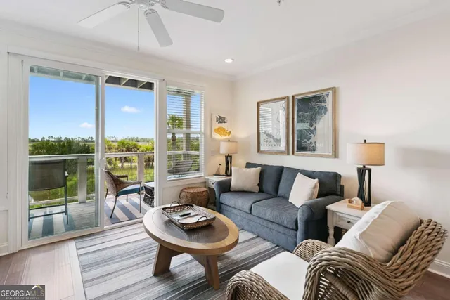 a living room with furniture and a floor to ceiling window