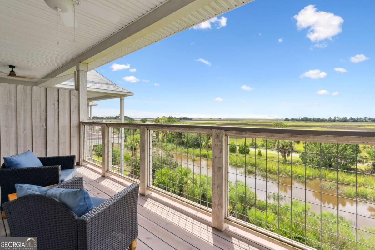 16 Hidden Harbor Road Brunswick, GA 31525 - Photo 10 of 42 a living room with furniture and a floor to ceiling window