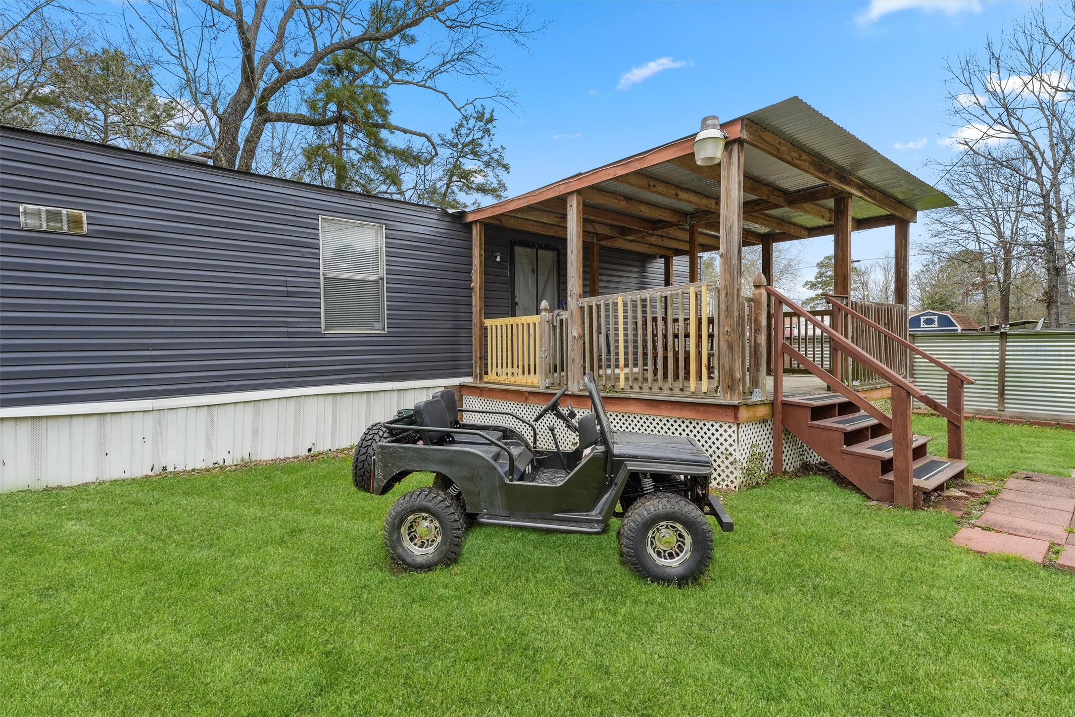 a house view with a garden space and deck