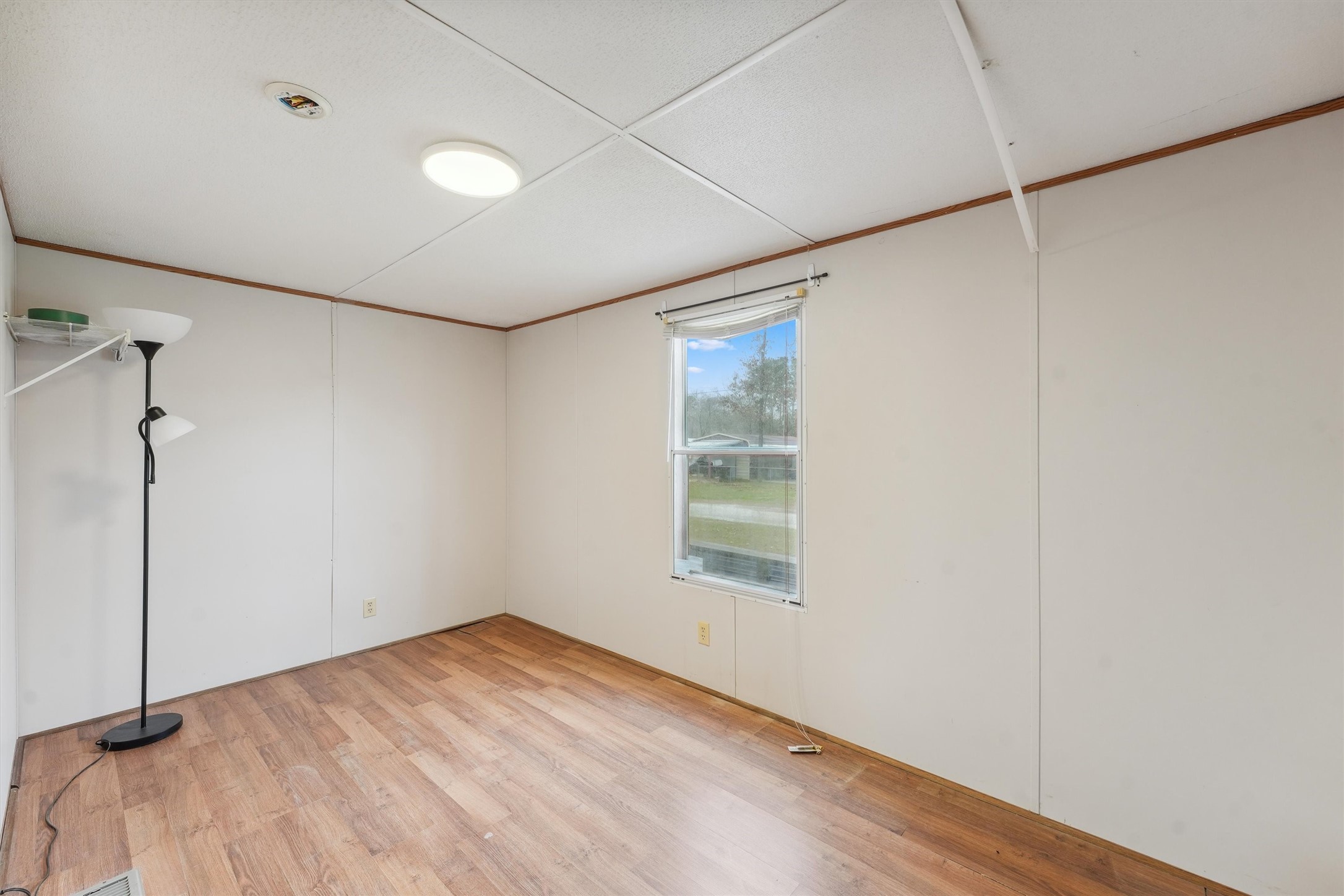 231 Monte Carlo Road Point Blank, TX 77364 - Photo 12 of 15 a view of a room with wooden floor and windows