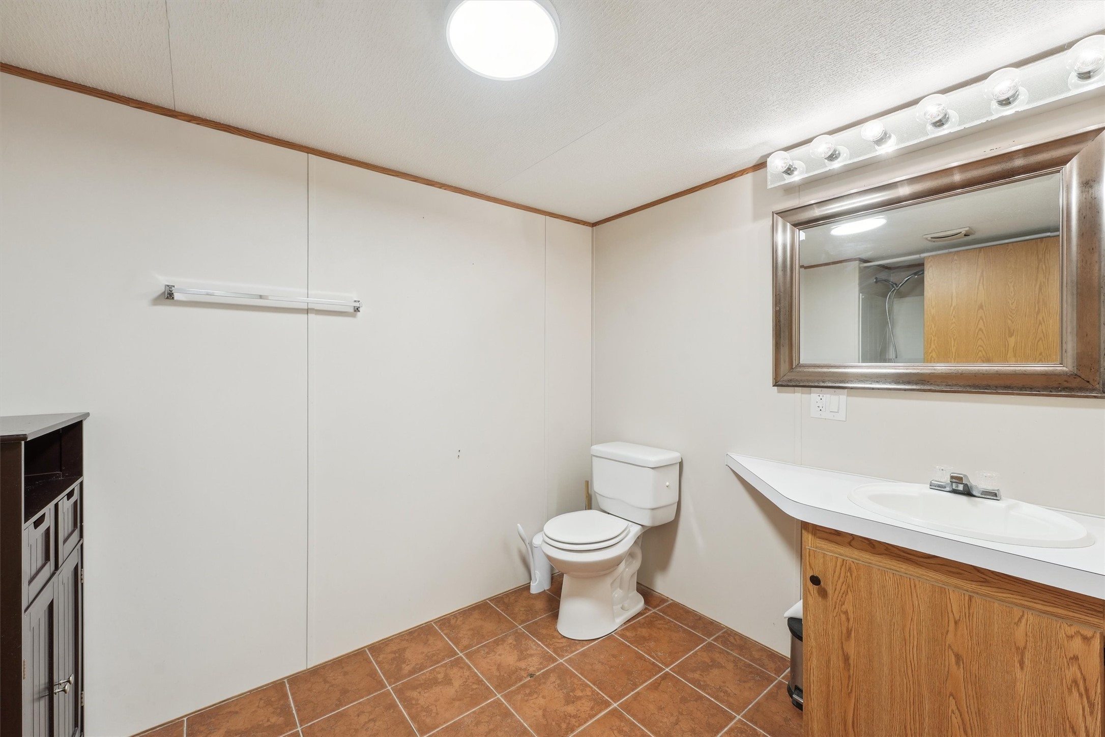231 Monte Carlo Road Point Blank, TX 77364 - Photo 7 of 15 a bathroom with a sink and a mirror