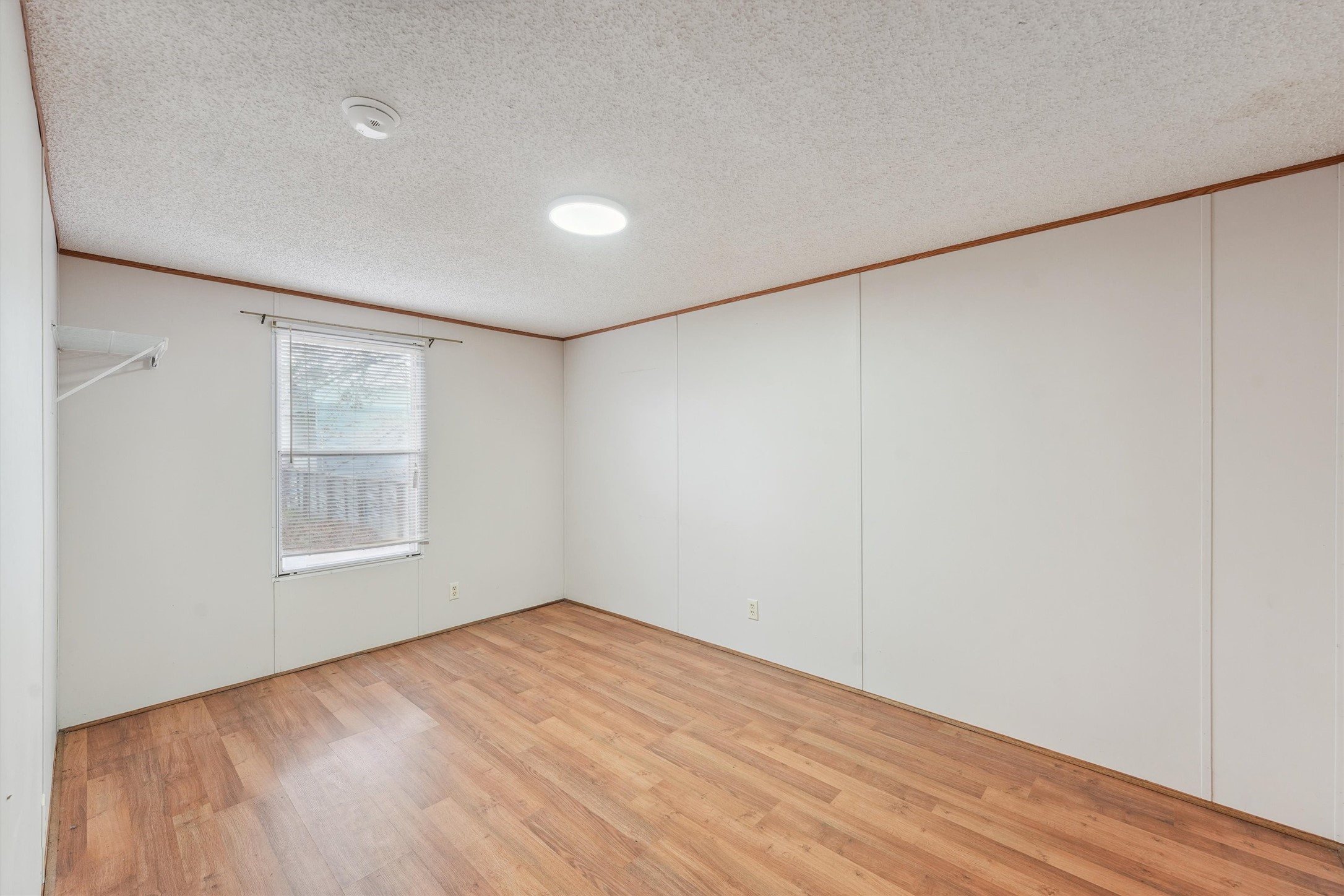 231 Monte Carlo Road Point Blank, TX 77364 - Photo 8 of 15 a view of empty room with wooden floor and fan
