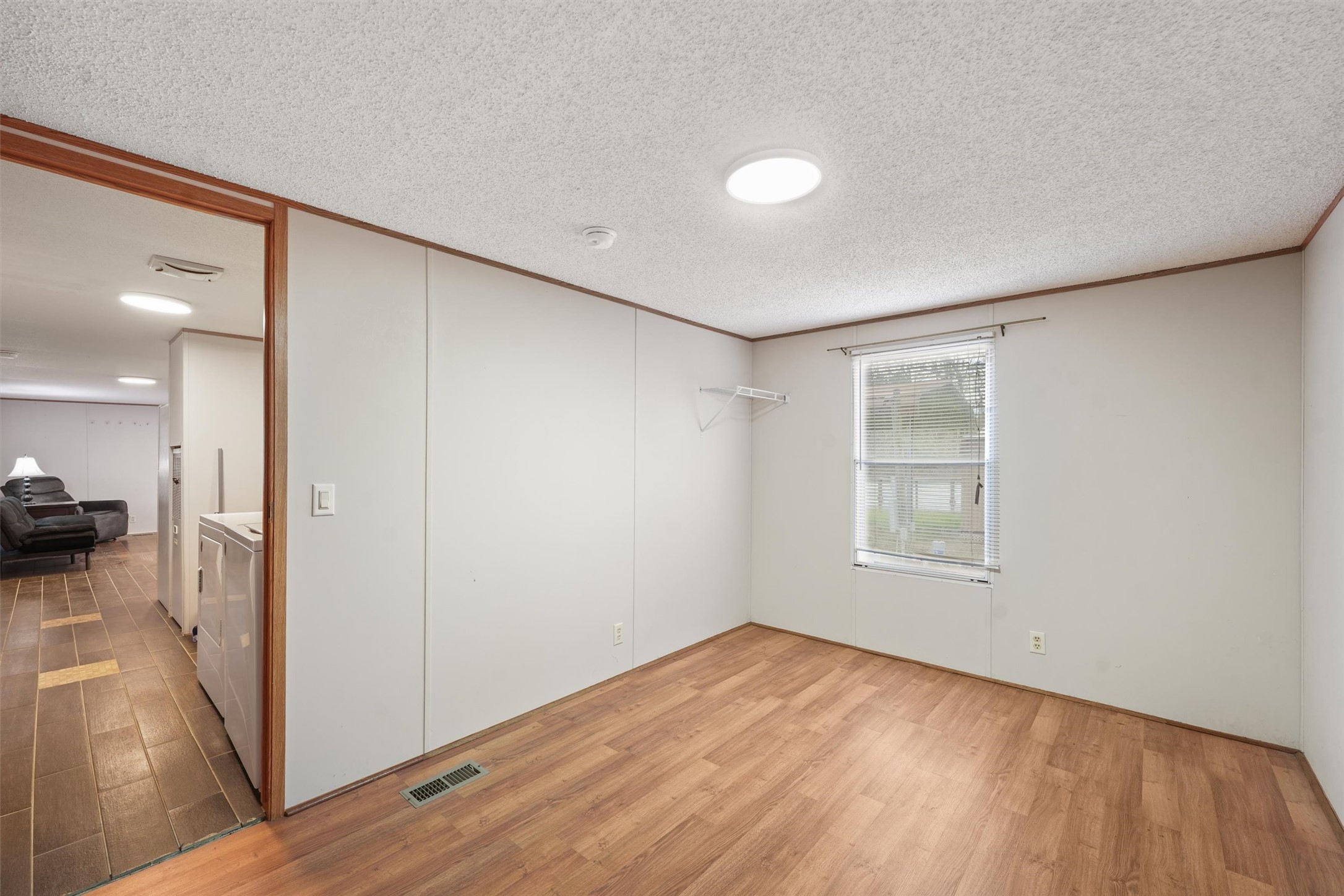 231 Monte Carlo Road Point Blank, TX 77364 - Photo 9 of 15 an empty room with wooden floor and windows