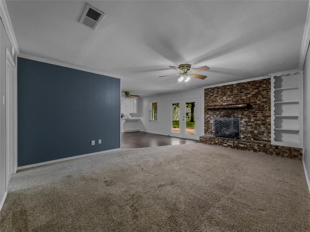 220 Cooper Drive Hurst, TX 76053 - Photo 7 of 27 a view of a livingroom with a fireplace and window
