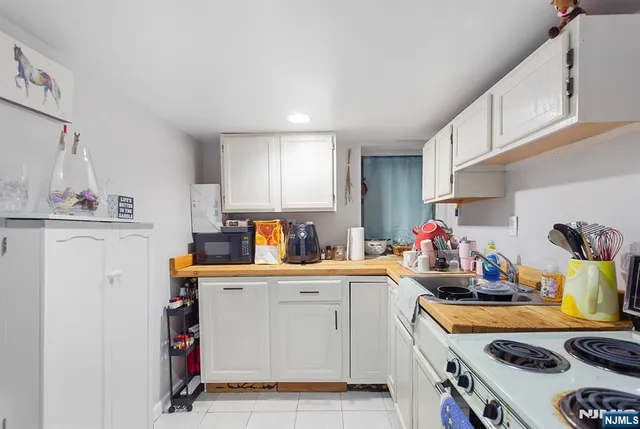a kitchen that has a sink and a stove in it