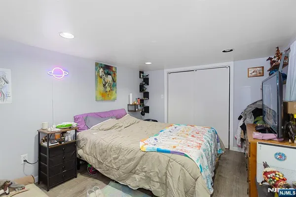 a bedroom that has a bed and a tv in it