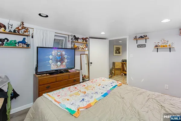 a bed room with a bed a television and a bed