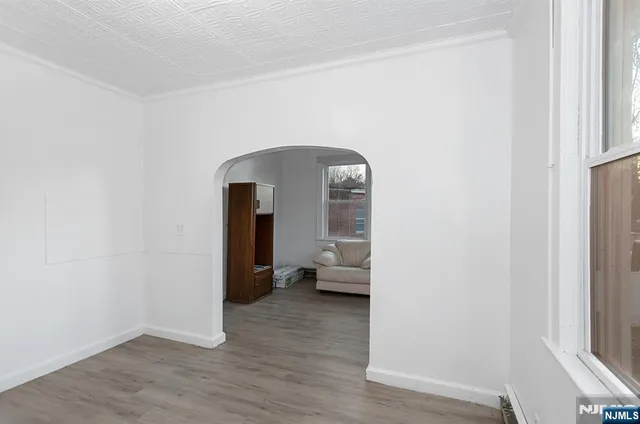 a view of a living hall with a wooden floor