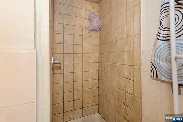 a bathroom with a sink a mirror and a shower