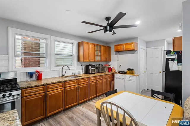 a kitchen with stainless steel appliances a sink stove and refrigerator