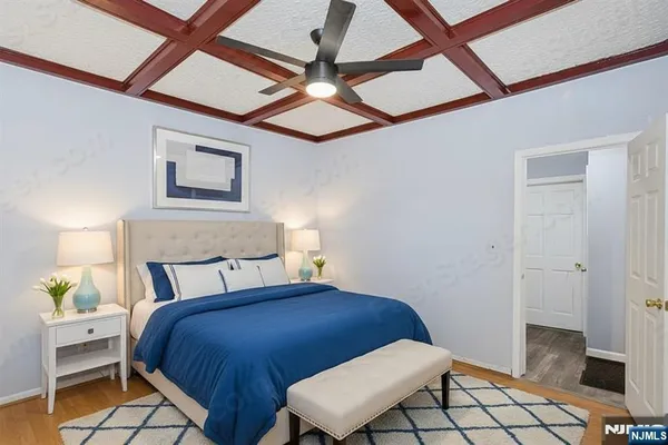 a bedroom with a bed and a lamp on the dresser