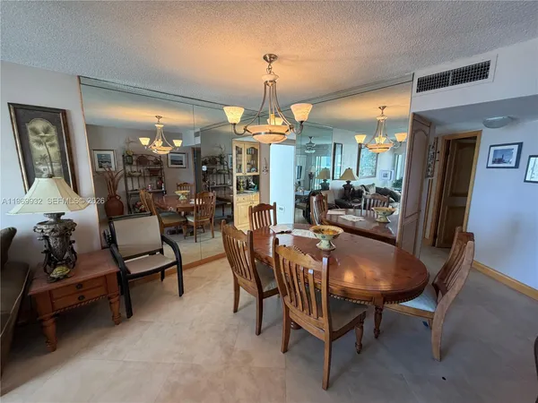 a living room with furniture a chandelier and a large window