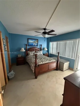 a bedroom with a bed and a mirror