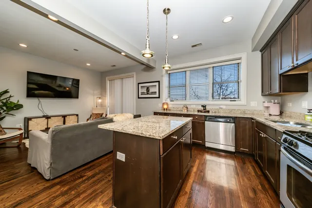 a kitchen with a stove window and cabinets