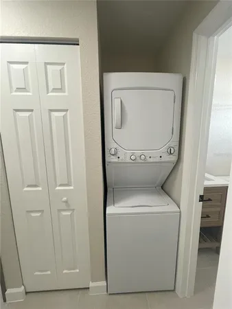 an empty room with a ceiling fan and shower