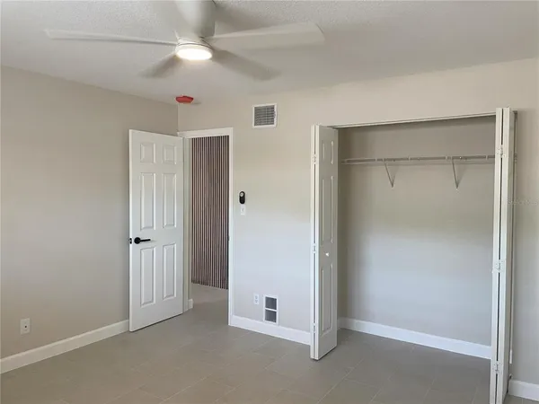 a bathroom with a bathtub shower sink vanity mirror and toilet