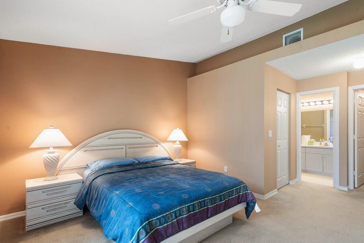 1050 Jeffery Street Boca Raton, FL 33487 - Photo 11 of 25 a bedroom with a bed and a lamp