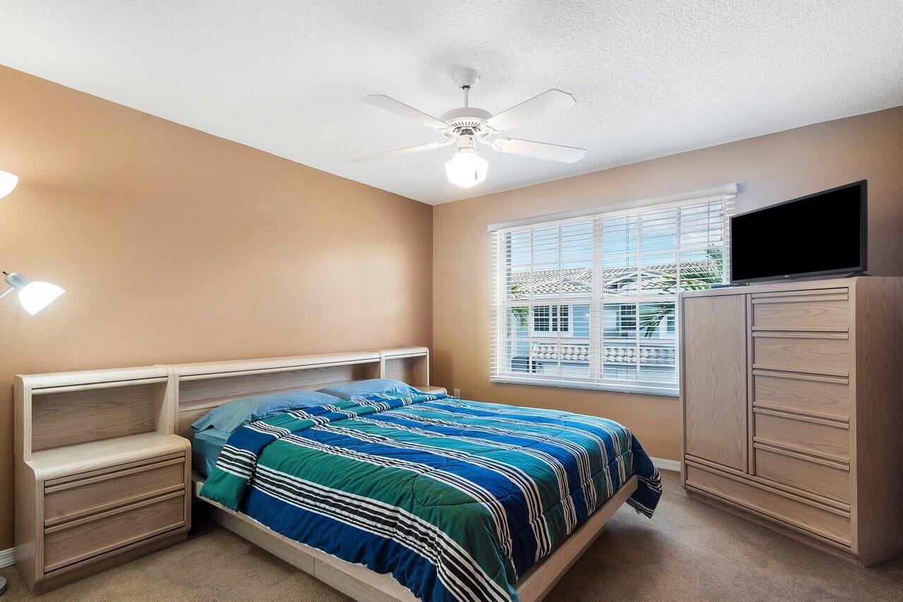 1050 Jeffery Street Boca Raton, FL 33487 - Photo 15 of 25 a bedroom with a bed and a flat screen tv