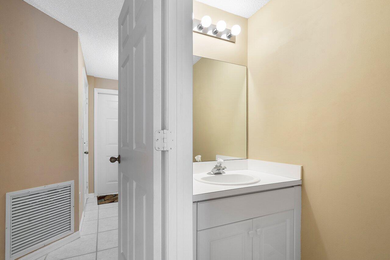 1050 Jeffery Street Boca Raton, FL 33487 - Photo 6 of 25 a bathroom with a sink and a mirror