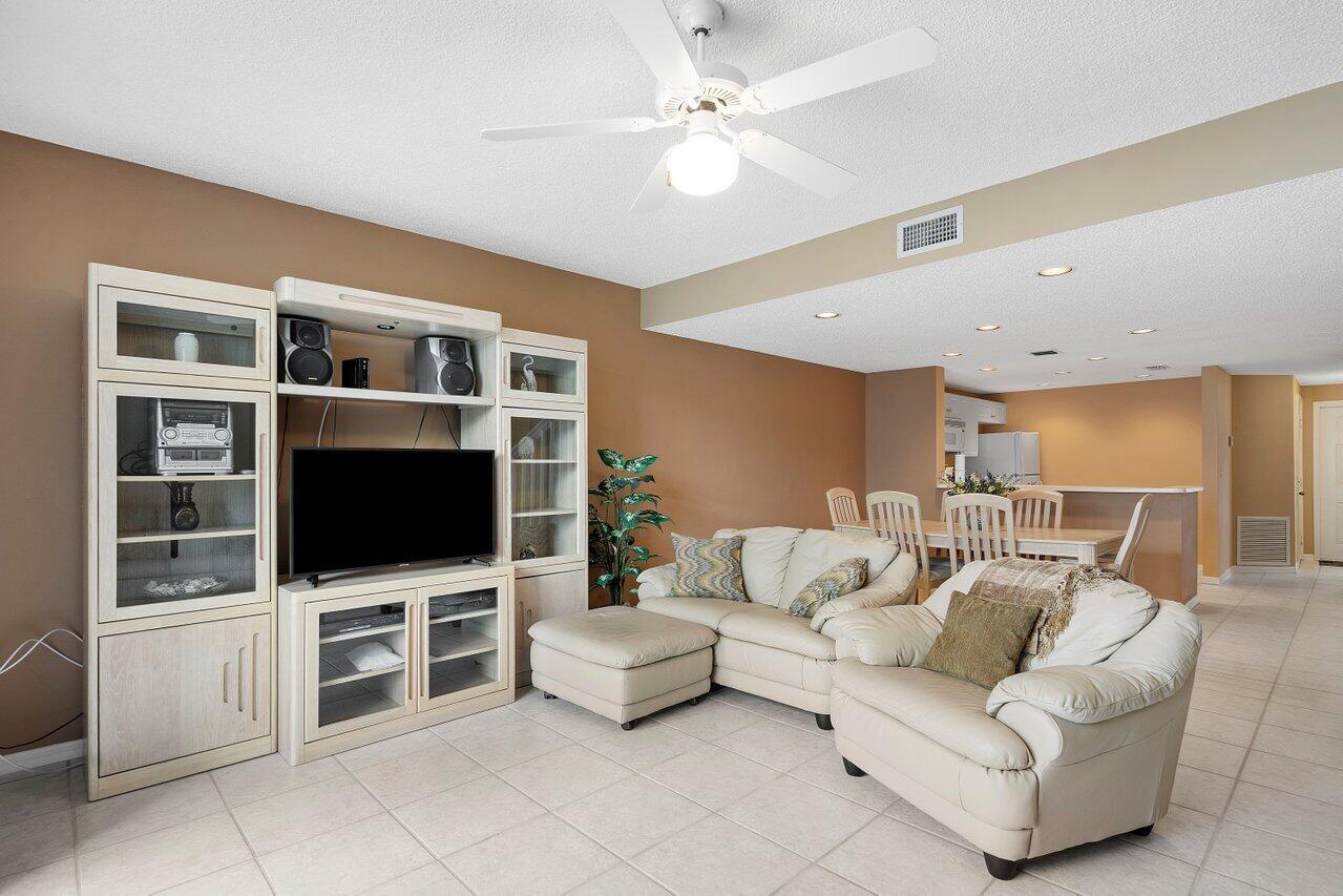 1050 Jeffery Street Boca Raton, FL 33487 - Photo 8 of 25 a living room with furniture and a flat screen tv