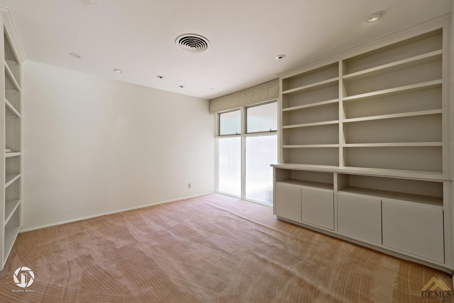 Undisclosed Address Bakersfield, CA 93309 - Photo 42 of 63 a view of an empty room with a cabinet and a window
